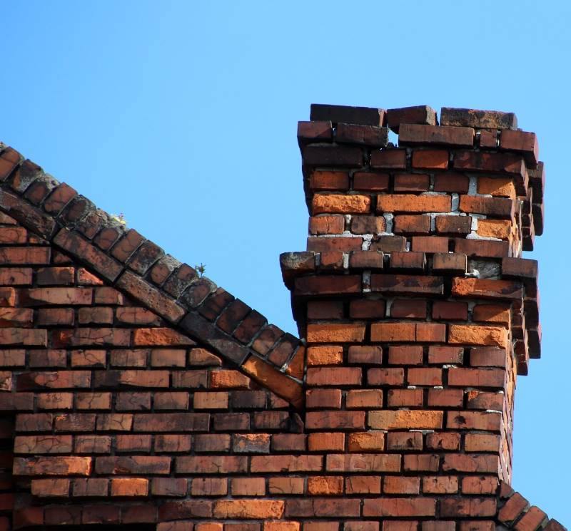 Damaged chimney on an Glenn Dale home showing cracks and missing mortar